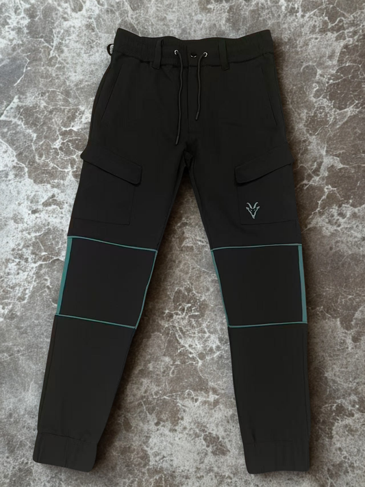 Black construction workwear cargo trousers with teal accents on a textured surface