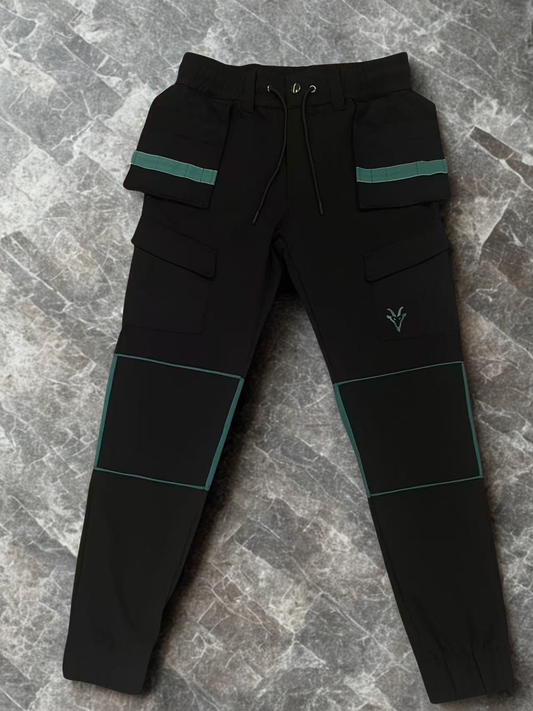 Black work wear trousers with green accents on a gray marble surface